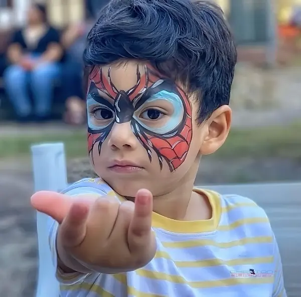 Happy child with colorful face painting